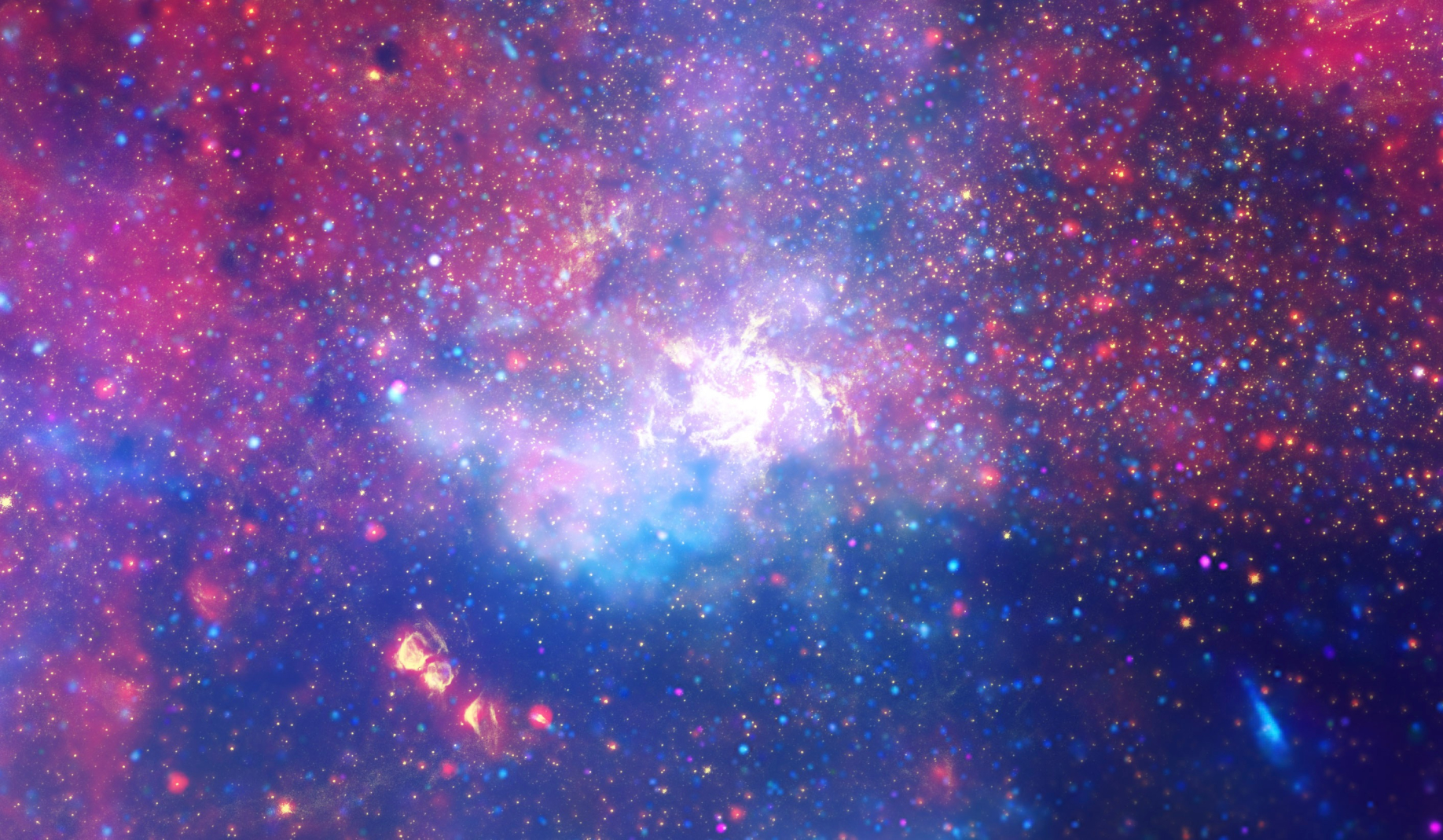 Ogroman vrtlog vrućeg plina koji svijetli infracrvenom svjetlošću, označavajući približnu lokaciju supermasivne crne rupe u srcu naše galaksije Mliječni put. Vizualno obrađena verzija slike koju je snimio Hubble 2009. godine (©NASA/ ESA/ SSC/ CXC/ STScI).