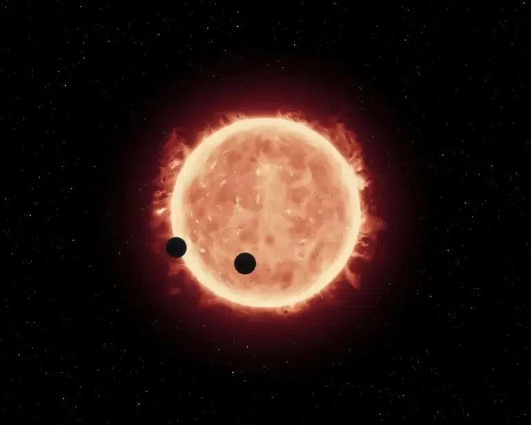 Ova umjetnička ilustracija prikazuje dva svijeta veličine Zemlje kako prolaze ispred svoje matične zvijezde, crvenog patuljka u sustavu TRAPPIST-1, udaljenom 40 svjetlosnih godina. Zasluge: ESA/Hubble